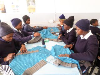 GRADE 7 Sewing the frills on to their Aprons b